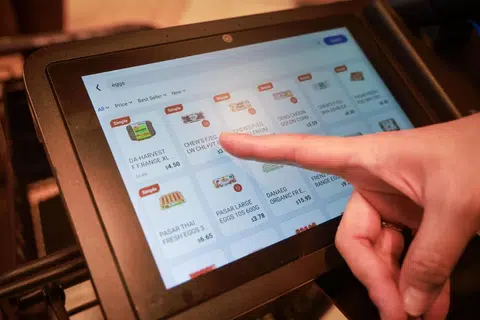 Seorang pelanggan menggunakan troli pintar, atau Smart Cart, untuk melihat barangan yang ditawarkan di FairPrice Finest, Punggol Coast Mall pada 20 April.