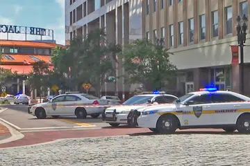 KEJADIAN TEMBAKAN: Foto menunjukkan kenderaan polis mengepung jalan ke kawasan Jacksonville Landing di mana beberapa orang terkorban dan 11 yang lain cedera, selepas seorang peserta pertandingan melepaskan tembakan sebelum menembak diri sendiri. - Foto AFP