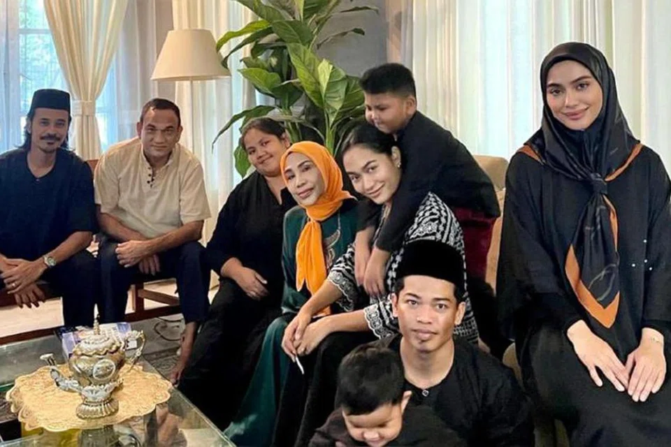 LEBARAN BERSAMA KELUARGA: Rohana Jalil (bertudung jingga) bersama suami dan anak-anak meraikan Hari Raya.