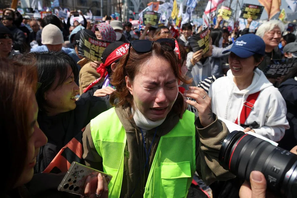 Seorang wanita agak emosional ketika orang ramai meraikan pemecatan Presiden Yoon Suk Yeol, berhampiran Mahkamah Perlembagaan di Seoul, Korea Selatan, 4 April 2025.