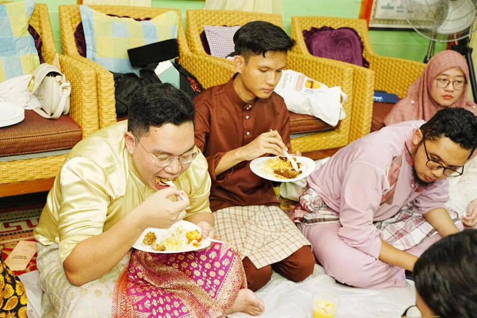 Hadirin menikmati hidangan nasi ambeng dan kuih-muih tradisional di perjumpaan Hari Raya wadah digital Berita Harian, OMGxBH, di Kampong Lorong Buangkok. 