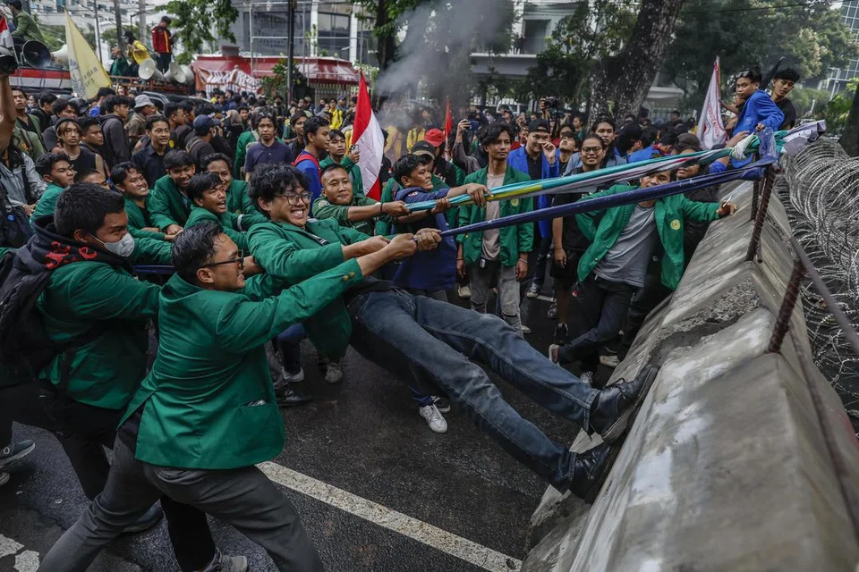 Sekumpulan mahasiswa merobohkan penghadang semasa protes anti-pemerintah berhampiran Istana Presiden di Jakarta, Indonesia, pada 17 Februari 2025. Ratusan mahasiswa mengadakan demonstrasi bagi membantah dasar terbaru pemerintah berkaitan kecekapan bajet.