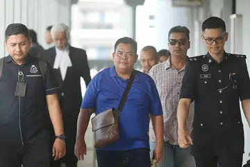 Mahkamah Sesyen Kuala Lumpur pada 22 April mengenakan hukuman denda RM12,000 terhadap seorang pekebun sawit, Samsuri Ramli, 45 tahun (tengah), kerana membuat hantaran bersifat mengancam kepada Yang di-Pertuan Agong menerusi Facebook.