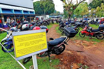 LEBIH TERATUR: Pekerja Malaysia boleh meletakkan motosikal di kawasan letak kenderaan percuma ini ketika singgah bersarapan di pusat penjaja Marsiling Lane. - Foto BH oleh SAINI SALLEH