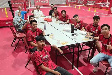 BERLATIH DAN BERBUKA BERSAMA: Presiden Mohd Nasri Haron (berkemeja putih), jurulatih Padzli Othman (kemeja-T biru) dan isterinya, Cik Halizah Minsawi, berbuka dengan pemain skuad U-17 nasional sebelum memulakan latihan pusat di Heartbeat@Bedok baru-baru ini. - Foto PERSES