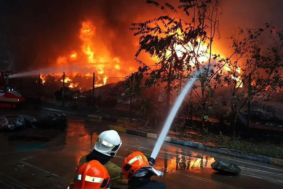 Ahli bomba memadamkan api yang sedang berlaku di Tuas Crescent sejak 6 pagi tadi. FOTO: FACEBOOK/ SCDF