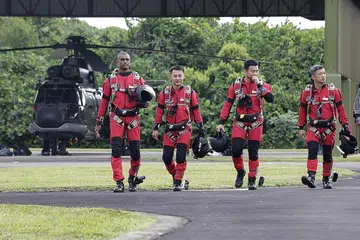 GAGAH PERKASA: Anggota pasukan Red Lions, yang cukup diminati warga Singapura ketika NDP, dirakam bersiap siaga dalam acara media di Pangkalan Udara Sembawang, Sembawang Road, baru-baru ini. - Foto SPH