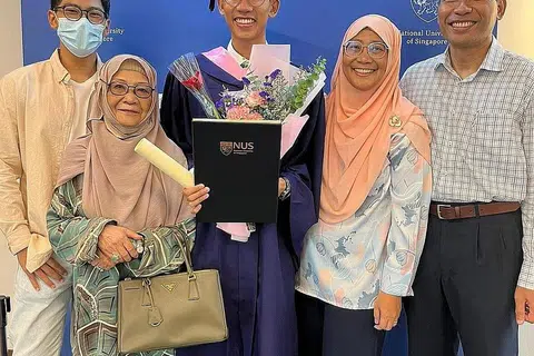 MINAT MENDALAM TENTANG HAL KAUM DAN AGAMA: Encik Ahmad Zaki Yazid (tengah) bersama anggota keluarganya, (dari kiri) adiknya, Ahmad Shafi Yazid; neneknya, Cik Hadijah Mohamed; ibunya, Cik Aslinda Ahmad; dan ayahnya, Encik Yazid Mohamed Ali selepas meraih ijazah Kepujian (Kecemerlangan Tertinggi) dalam bidang Sejarah dari Universiti National Singapura (NUS). - Foto ihsan AHMAD ZAKI YAZID