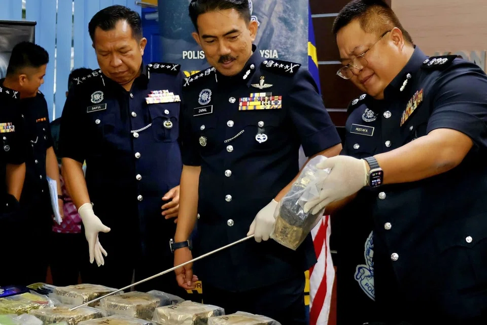 Pesuruhjaya Polis Sarawak, Datuk Mohamad Zainal Abdullah (tengah), melihat dadah yang dirampas pada sidang media di Ibu Pejabat Polis Kontinjen Sarawak pada 29 September.
