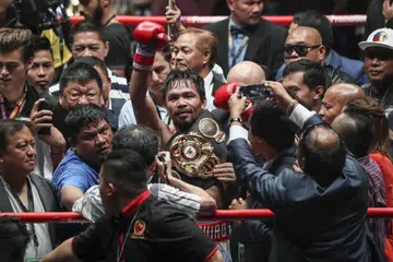 Ikon tinju Filipina Manny Pacquiao (tengah) meraikan kejayaan mengalahkan Lucas Matthysse dari Argentina dalam kejohanan WBA, digelar 'Fight of the Champions', di Kuala Lumpur, Malaysia, pada 15 Julai 2018. 