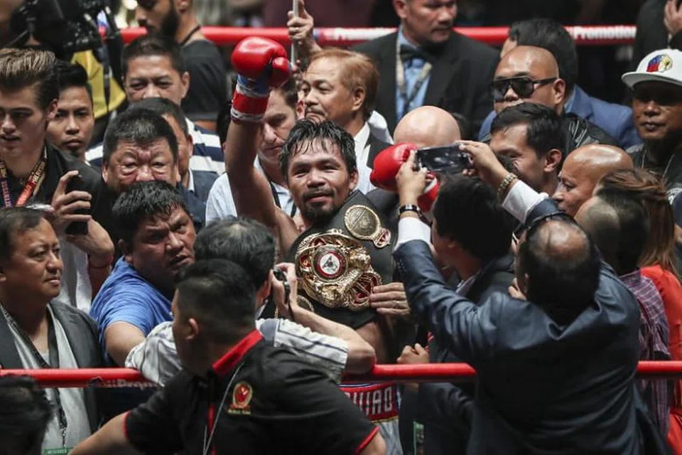 Ikon tinju Filipina Manny Pacquiao (tengah) meraikan kejayaan mengalahkan Lucas Matthysse dari Argentina dalam kejohanan WBA, digelar 'Fight of the Champions', di Kuala Lumpur, Malaysia, pada 15 Julai 2018. 