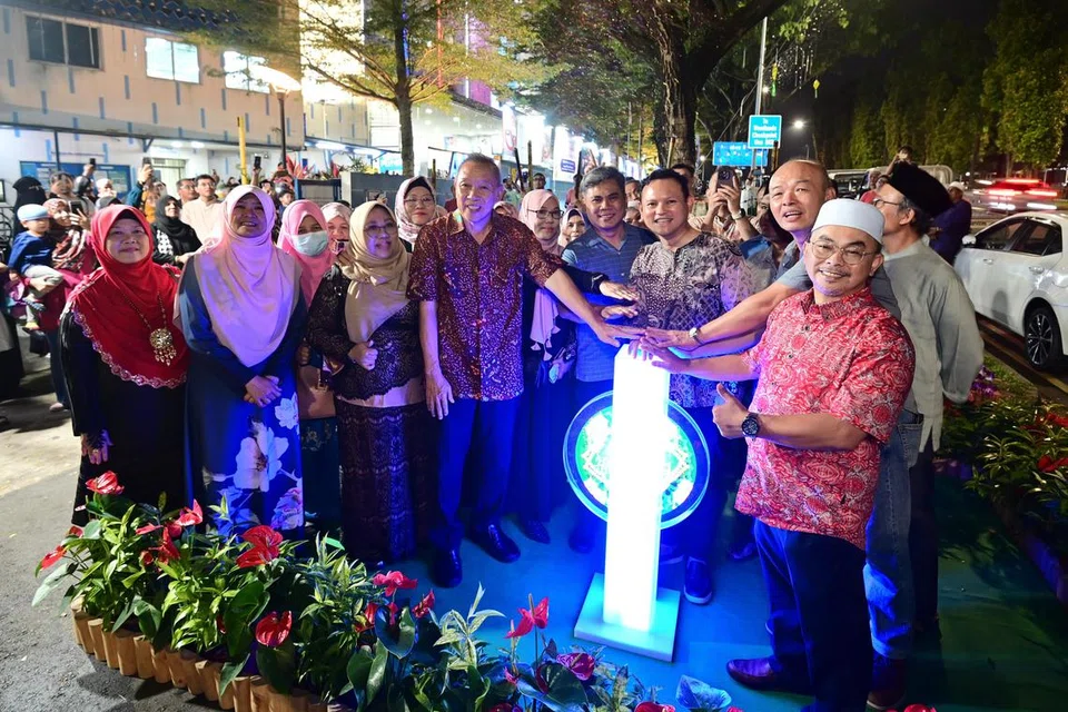 Menteri Negara Kanan (Pertahanan merangkap Tenaga Manusia), Encik Zaqy Mohamad (tengah, berbaju kurta), melancarkan penyalaan lampu Hari Raya di Admiralty Road.