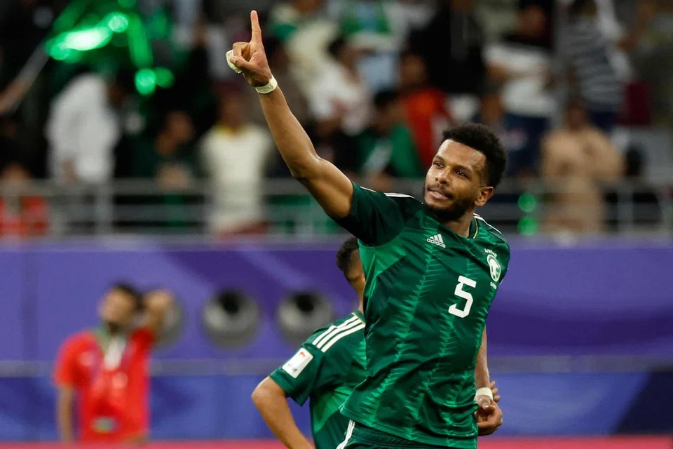 GOL LEWAT: Pemain pertahanan Arab Saudi, Ali Al-Bulayhi, meraikan kemenangan 2-1 mereka ke atas Oman dalam aksi pembukaan Kumpulan F Piala Asia di Stadium Antarabangsa Khalifa pada 16 Januari.