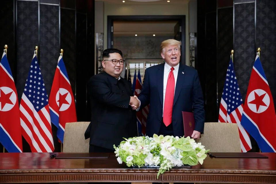 Presiden Amerika Syarikat, Donald Trump, dan pemimpin Korea Utara, Kim Jong Un, berjabat tangan selepas menandatangani deklarasi bersama sempena sidang kemuncak bersejarah Trump-Kim di Hotel Capella, Singapura, pada 12 Jun 2018.