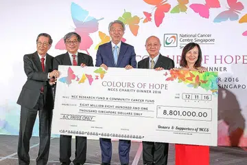 USAHA MELAWAN BARAH: Timbalan Perdana Menteri Teo Chee Hean (tengah) bersama cek sekitar $8.8 juta yang telah dikumpulkan NCCS dalam bentuk ikrar dan derma bagi penjagaan pesakit barah dan inisiatif kajian. Antara barang yang dilelong dan hasilnya didermakan untuk tujuan itu ialah tembikar yang dihasilkan Dr Iskandar Jalil yang dilelong pada harga $20,000. - Foto-foto SHAHIDA SARHID.