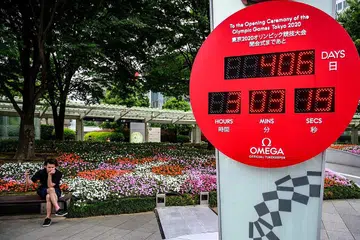 AKAN USAHAKAN OLIMPIK SELAMAT: Thomas Bach memberitahu media selepas mesyuarat lembaga eksekutif IOC di Switzerland kelmarin badan itu komited menganjurkan Olimpik Tokyo tahun depan. Sebuah jam pengiraan detik pelancaran Tokyo 2020 di Roppongi, di Tokyo, kelihatan pada 12 Jun lalu. - Foto REUTERS, AFP