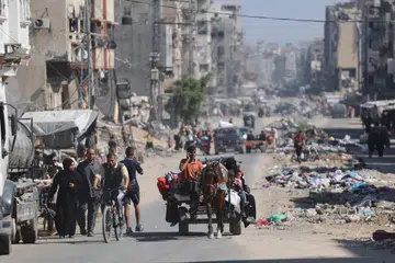 Rakyat Palestin mengangkut barang mereka ketika melarikan diri dari kawasan utara Jaluran Gaza pada 12 Oktober.