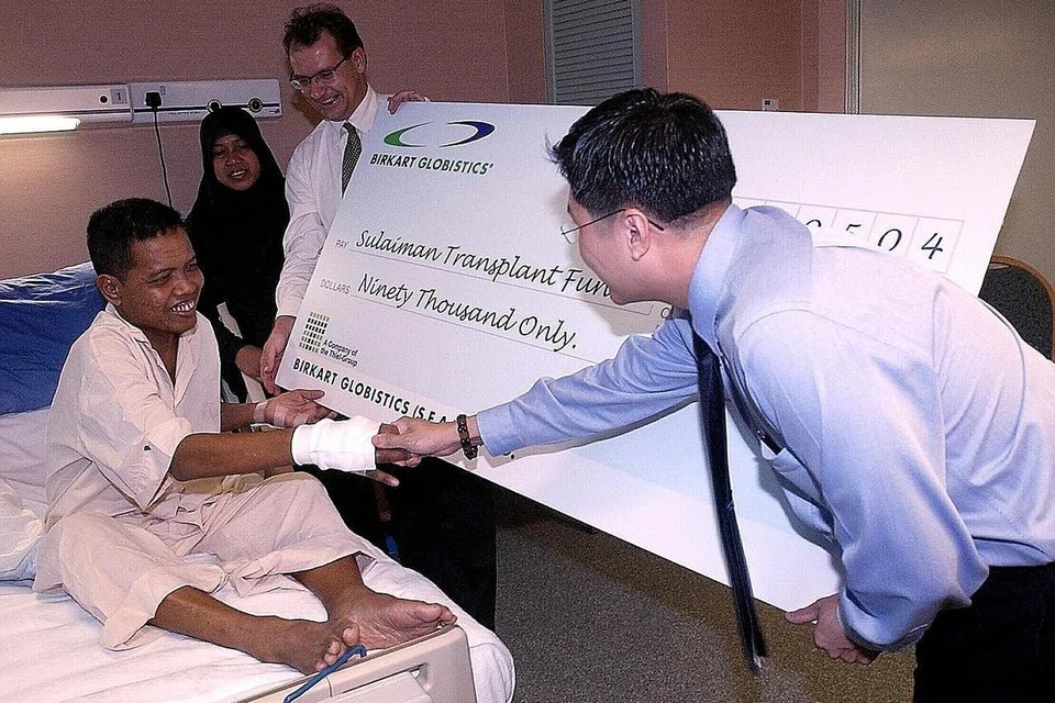 TERIMA SUMBANGAN: Pada 2004, Encik Sulaiman menerima sumbangan $90,000 daripada majikannya ketika itu, Birkat Globistics, untuk menampung sebahagian kos pembedahannya. - Foto fail 