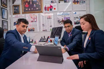 Encik Sirajudeen Syed Mohamed (kiri) berbincang bersama kakitangannya, Encik Muhamed Haris dan Cik Joy Valbaraz (kanan).