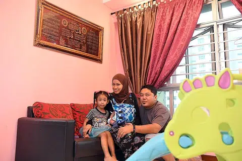 BERJAYA BERHENTI MEROKOK: Encik Azmi bersama isteri, Cik Nur Raini Mohamed Rashid, 32 tahun, anak mereka Nur Zara Alayna,4 tahun, and bayi berusia sebulan, Nur Zayyan Arrizky, di rumah mereka.- Foto BH oleh DESMOND FOO