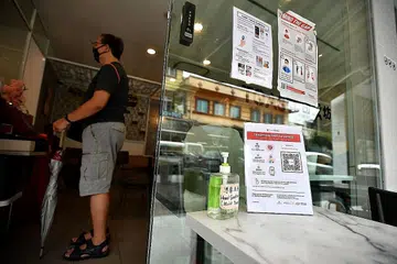 BELUM WAJIB: Papan tanda TraceTogether di depan kedai Toast Box pada 11 Januari lalu. - Foto BH Oleh LIM YAOHUI