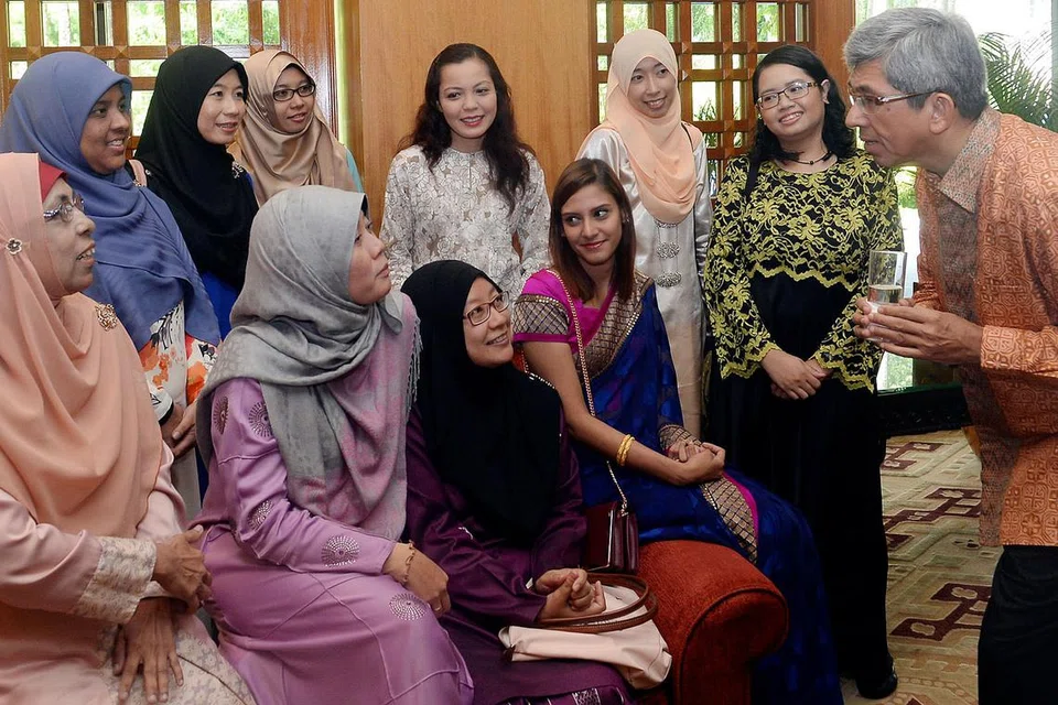 BERI MAKLUM BALAS: Dr Yaacob (kanan) berinteraksi dengan beberapa daripada 150 pegawai perkhidmatan awam yang menghadiri jamuan tengah hari sempena Hari Raya Aidilfitri di Hotel Regent Singapore semalam. - Foto TAUFIK A. KADER