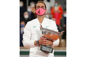 UNGGUL DI PARIS: Kemenangan kejuaraan ke-13 Nadal di Roland Garros kelmarin sekali gus menandingi rekod Roger Federer merangkul 20 kejuaraan Grand Slam lelaki. - Foto AFP