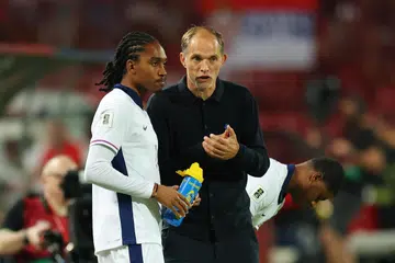 Pengurus England, Thomas Tuchel (kanan), memberi arahan kepada pemain England, Djed Spence, sebelum beliau dimasukkan sebagai pemain gantian ketika perlawanan menentang Serbia. 