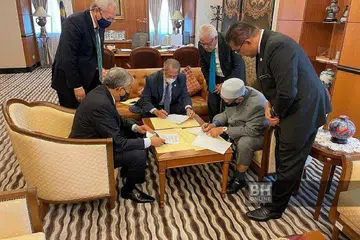 DULU BEKERJASAMA: Tan Sri Muhyiddin Yassin (duduk, tengah) bersama Datuk Seri Dr Ahmad Zahid Hamidi (duduk, kiri) dan Tan Sri Abdul Hadi Awang (duduk, kanan) menandatangani dokumen selepas pertemuan enam mata berhubung kemelut politik Perak di Bangunan Parlimen pada Disember 2020, dalam usaha membentuk kerjasama antara tiga parti utama melibatkan Perikatan Nasional, Umno dan PAS. - Foto fail/ TWITTER DATUK TAKIYUDDIN HASSAN