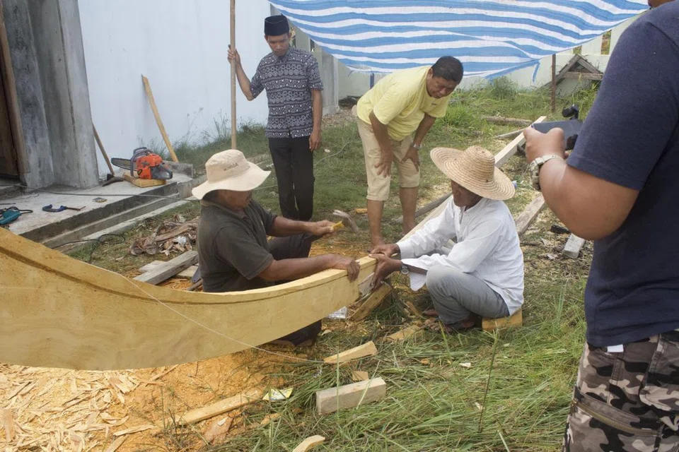 BUAT KOLEK BERSAMA: Orang kampung di Pulau Sugi, Riau, iaitu kampung Encik Fawzi, bergotong-royong membina kolek baru bersama pada 2019. Dalam gambar ini, mereka sedang melakukan cantuman kayu lunas dan sauk yang menjadi dasar kolek.
