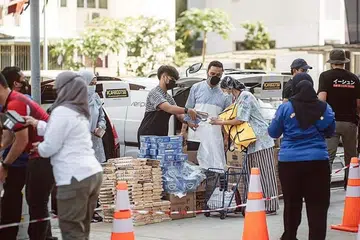 'KEDAI RUNCIT' DI TEMPAT LETAK KERETA: Salah satu inisiatif yang diusahakan TheJumaatInitiatives bersama syarikat Pengurusan Acara Ghifari adalah CarbootSG di mana penduduk boleh datang dan mengambil barangan rumah yang diperlukan secara percuma. - Foto THEJUMAATINITIATIVES