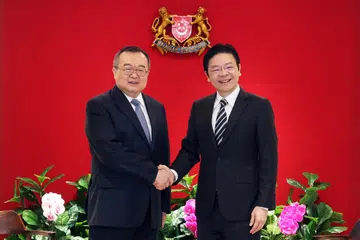Timbalan Perdana Menteri, Encik Lawrence Wong (kanan), bertemu Menteri Jabatan Antarabangsa Parti Komunis China, Encik Liu Jianchao, yang sedang mengadakan lawatan ke Singapura pada 26 Mac.