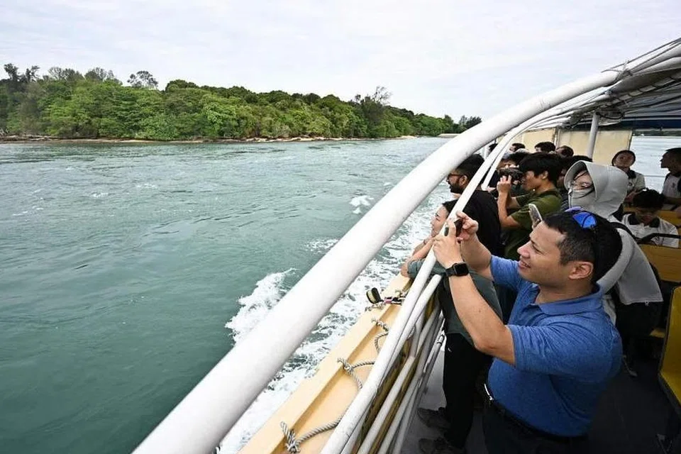Menteri Pembangunan Negara, Encik Desmond Lee (kanan), melihat selatan pulau Lazarus semasa lawatan ke Kepulauan Selatan pada 9 Mei. 