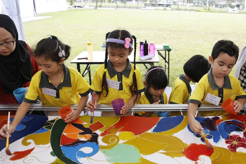 PELBAGAI KEGIATAN DIADAKAN: Orang ramai yang menyertai sambutan ulang tahun pertama WGS berpeluang menikmati pelbagai kegiatan. Ini termasuk acara menghasilkan lukisan batik anjuran Kamal's Arts Studio, yang turut disertai sekumpulan kanak-kanak, untuk memecahkan rekod dunia bagi lukisan batik terpanjang berukuran 500 meter dan kegiatan menanam pokok di Kebun Kami @ WGS, yang dibuka rasmi oleh Timbalan Perdana Menteri, Encik Heng Swee Keat, pada Sabtu lalu. - Foto BH oleh AZMI ATHNI