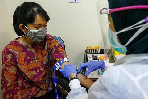 JALANI UJIAN: Kakitangan hospital mengambil sampel darah bagi ujian Covid-19 di Hospital Pertamina Central baru-baru ini. Presiden Jokowi berharap program vaksinasi Covid-19 kebangsaan akan bermula pada Januari 2021. - Foto REUTERS