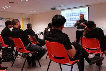 JAGA KESELAMATAN: Sebagai pegawai penyelia ruang latihan menembak di Certis, Encik Abdul Gafoor Haji Abdul Rahman memberi taklimat menyeluruh kepada pasukannya sambil menekankan prosedur dan arahan keselamatan. Semasa di SAF Encik Abdul Gafoor menyandang pelbagai jawatan dalam SAF - termasuk Sarjan Mejar Rejimen Pusat Latihan Logistik Tentera Darat . - Foto-foto CERTIS GROUP, ihsan ABDUL GAFOOR ABDUL RAHMAN