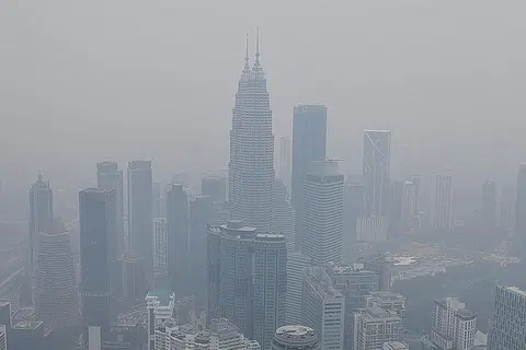 KEADAAN BERJEREBU: Beberapa mercu tanda di Malaysia, termasuk Menara Berkembar Petronas 'ditelan' jerebu pada tengah hari semalam ekoran kualiti udara rendah akibat fenomena jerebu. - Foto AFP