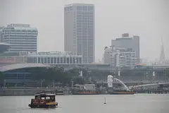 TERUS BERJEREBU: Beginilah keadaan Marina Bay (atas) dan Taman di Persisiran sekitar 2 hingga 3 petang semalam. - Foto BH oleh JASON QUAH, AFP
