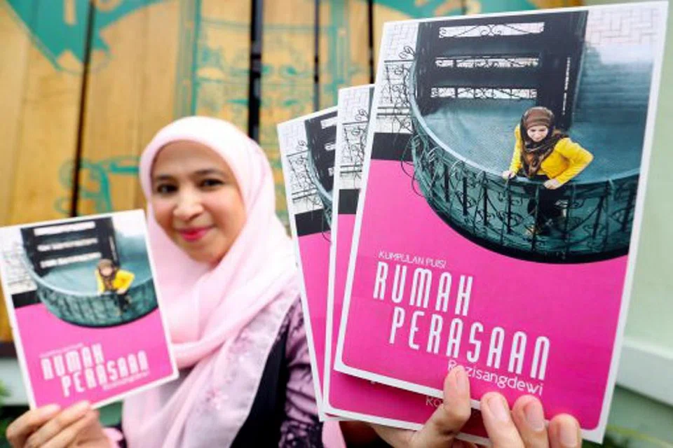 KONGSI KARYA: Rozi Abdul Razak menunjukkan antologi 'Rumah Perasaan' semasa majlis pelancaran buku puisi sulungnya, yang antara lain merakamkan sajak khusus buat penyanyi Siti Nurhaliza. - Foto NEW STRAITS TIMES