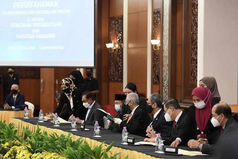 Perdana Menteri Malaysia, Ismail Sabri Yaakob (duduk, keempat dari kanan) menandatangani perjanjian kerjasama dengan Pakatan Harapan pada 13 September 2021. - Foto PEJABAT PERDANA MENTERI, MALAYSIA 
