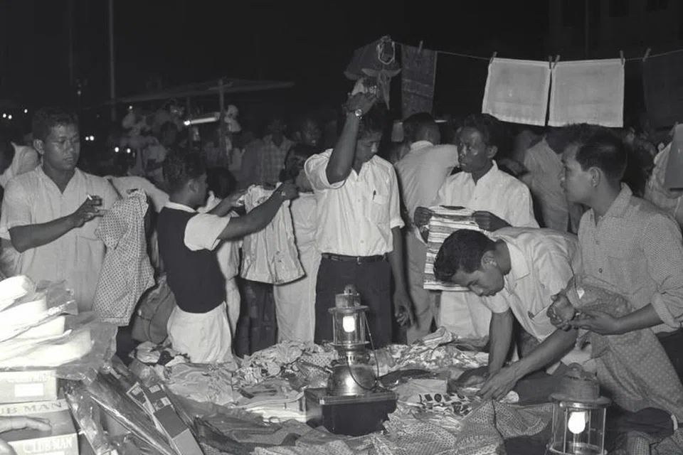 Pelanggan memilih barangan yang ingin dibeli di sebuah gerai di Geylang Serai pada 16 Mac 1961.