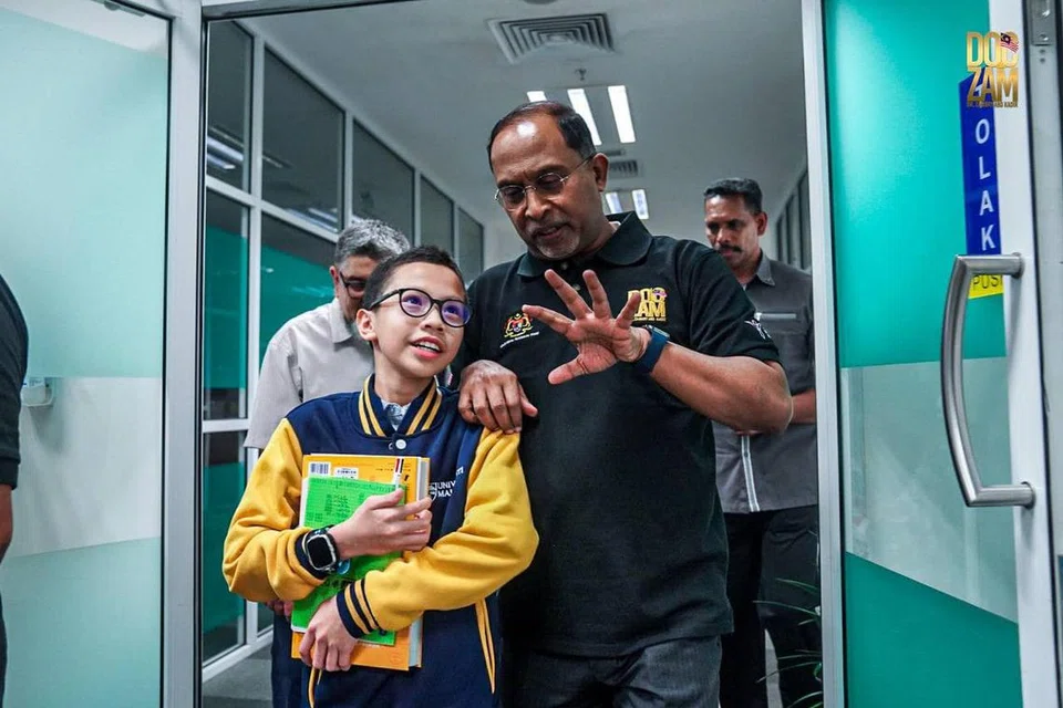 Menteri Pendidikan Tinggi Encik Zambry Abdul Kadir (kanan) berkongsi kata-kata semangat kepada Izz Imil, yang akan memulakan pengajiannya di Universiti Malaya.