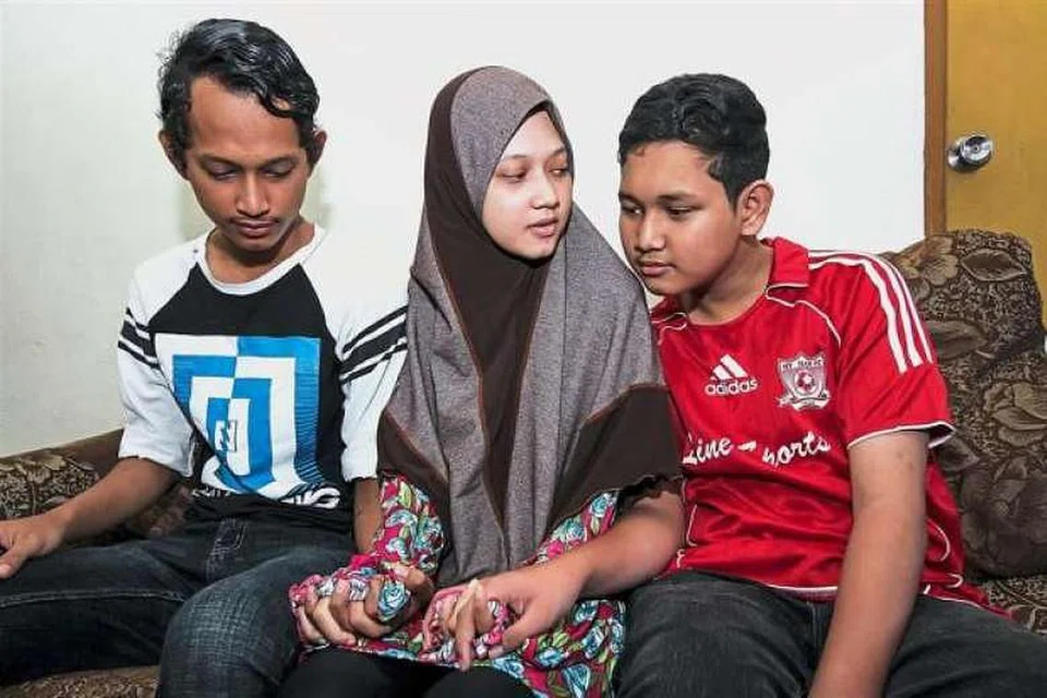 Tiga beradik -- (dari kiri) Muhammad Ridzuan, Nur Hidayah dan Muhammad Firdaus -- menjadi yatim piatu apabila ibu bapa mereka meninggal selang sehari akibat denggi.