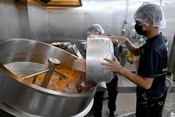 Pekerja di Asyura Paste memasukkan bahan-bahan untuk menghasilkan rempah paling laris dijual, iaitu ayam masak merah.