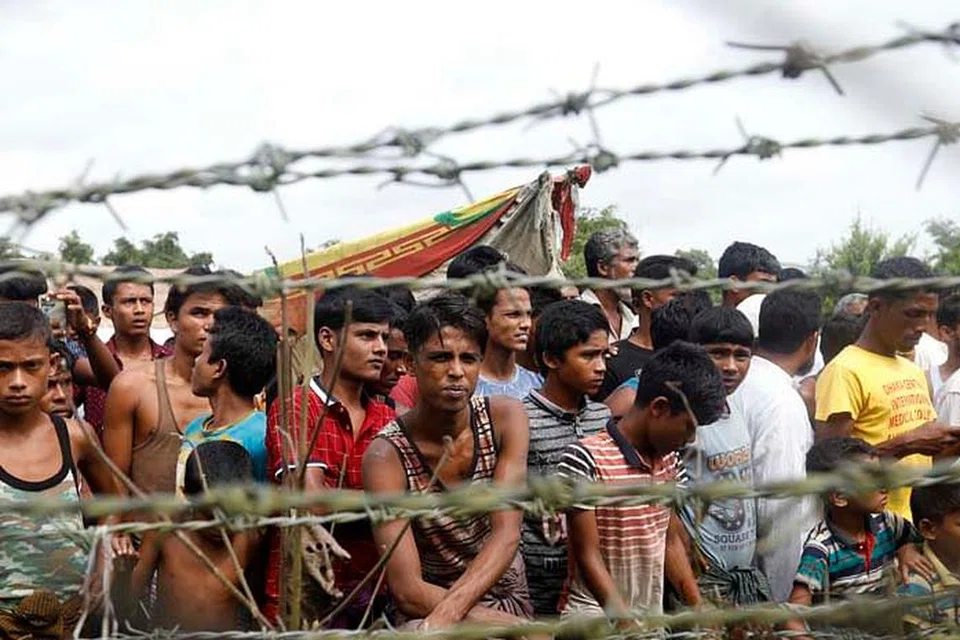 NASIB MALANG: Sekumpulan pelarian Rohingya berkumpul di belakang pagar berduri di sempadan Bangladesh-Myanmar. Menteri Luar Asean baru-baru ini melahirkan keprihatinan mendalam mengenai dakwaan tindakan keganasan yang berlaku ke atas kaum Rohingya. - Foto EPA