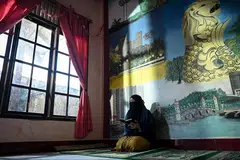 Cik Nurmayani Bensarong, 24 tahun, membaca Al-Quran di Panti Asuhan Muhammadiyah, Aceh, pada 8 Disember 2024. Sebagai penghuni panti asuhan itu sejak 2015, beliau berasa terhutang budi kepada Muhammadiyah yang telah memberikannya tempat berlindung dan pendidikan. Rasa syukur ini mendorongnya mengajar Al-Quran di Sekolah Berasrama Muhammadiyah sambil terus menetap di panti asuhan itu untuk membimbing penghuni baru, memastikan mereka mendapat sokongan dan peluang seperti yang pernah dinikmatinya.