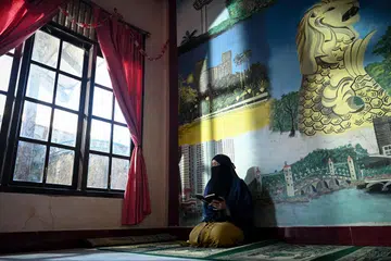 Cik Nurmayani Bensarong, 24 tahun, membaca Al-Quran di Panti Asuhan Muhammadiyah, Aceh, pada 8 Disember 2024. Sebagai penghuni panti asuhan itu sejak 2015, beliau berasa terhutang budi kepada Muhammadiyah yang telah memberikannya tempat berlindung dan pendidikan. Rasa syukur ini mendorongnya mengajar Al-Quran di Sekolah Berasrama Muhammadiyah sambil terus menetap di panti asuhan itu untuk membimbing penghuni baru, memastikan mereka mendapat sokongan dan peluang seperti yang pernah dinikmatinya.