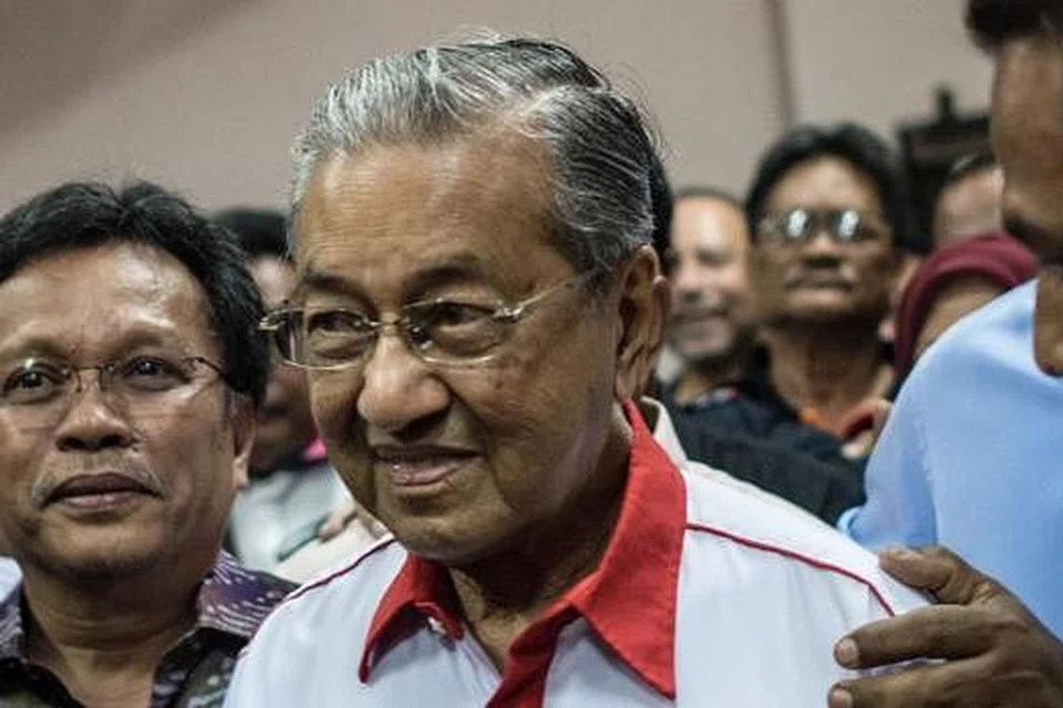 Tun Dr Mahathir tiba ke perhimpunan agung tahunan Umno Disember lalu. Gambar AFP 
