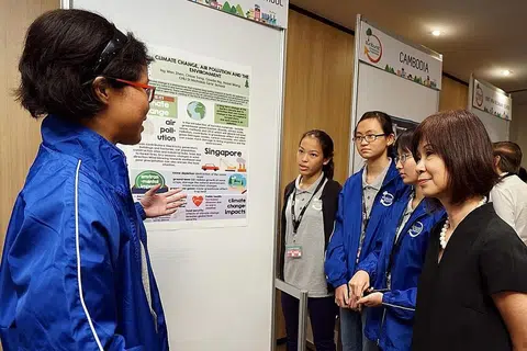KONGSI ISU ALAM SEKITAR: Para pelajar Sekolah CHIJ St. Nicholas Girls mengongsi projek mereka dengan Dr Amy Khor (kanan) di majlis pelancaran Program Alam Sekitar Sunburst STEP-NUS 2016. - Foto STEP