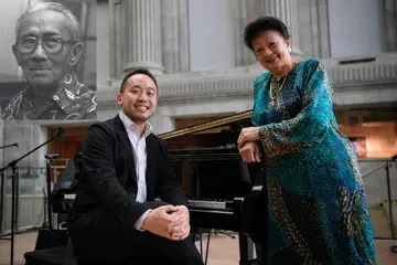IKTIRAF SUMBANGAN: Penggubah lagu setempat, Encik Julian Wong (kiri) bersama anak Allahyarham Encik Zubir, Dr Rohana Zubir berganding bahu bagi persembahan seni pencahayaan, Light to Night Festival, sempena memperingati dwi-abad negara ini, Bicentennial Singapura. - Foto BH oleh MARK CHEONG
